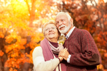 Happy senior couple in an autumn forest