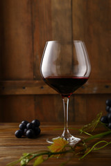 glass of red wine on wooden background