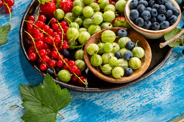 Local summer berries top view on wood