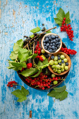 Fresh and local summer berries top view on wood