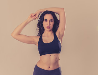 Obraz premium Portrait of sporty beautiful brunette woman in sport clothes looking sensual and fit