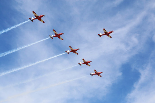 Plane show on a sunny day with cloud and blue sky in the background. - Powered by Adobe