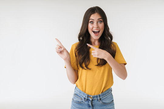 Image of caucasian brunette woman wearing casual clothes laughing and pointing fingers at copyspace