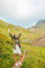 Beautiful happy young woman in mountains in the background of fog