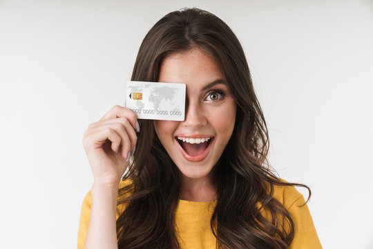 Image of gorgeous brunette woman wearing casual clothes smiling and holding credit card