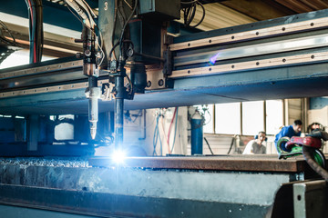 Plasma cutter in a factory cutting piece of metal