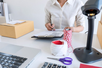 Shipment Online Sales, Small business or SME entrepreneur owner delivery service and working packing box, business owner working checking order to confirm before sending customer in post office