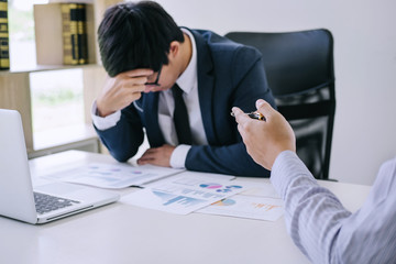 Boss and executive team feeling stress and serious of fail business, Team dispute of failure holding heads in hands with problems with a pile of work, sadness by bad news