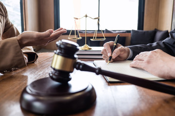 Businesswoman and Male lawyer or judge consult having team meeting with client, Law and Legal services concept