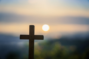 Cross on the blurred mountain natural background.