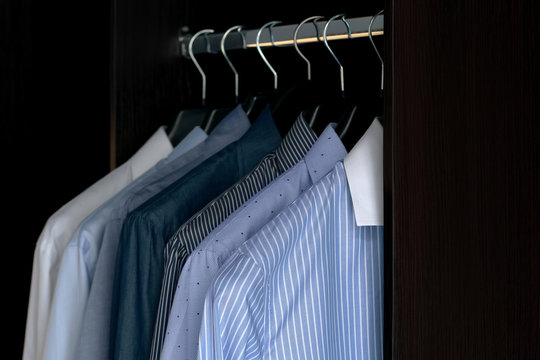  Close up of shirts hanging on a clothes hanger in atelier 