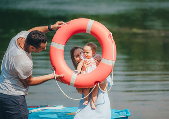 Mother, the father and the kid is a happy family. Family portrait