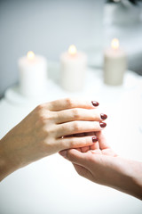 Manicurist demonstrates a hand with a beautiful gel polish