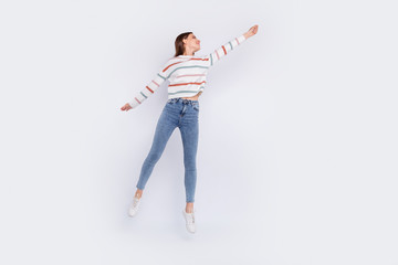 Full body photo of pretty lady holding her arm wearing striped sweater denim jeans isolated over white background © deagreez