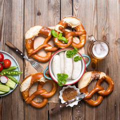 Pretzels, white bavarian sausages and beer on wooden background, german traditional food, oktoberfest - 286460527