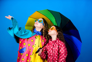 cheerful hipster children, sisterhood. rain protection. Rainbow. autumn fashion. happy small girls...