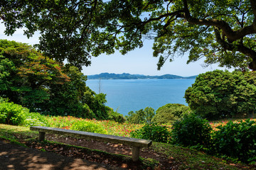 Bench on the island park, view on the sea