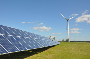 Wind turbines generating electricity and solar panels.