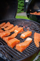 Delicious grilled pink wild salmon choped on smoking bbq cuisine