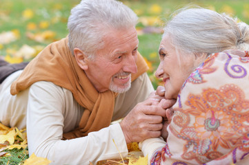 Happy senior woman and man in park