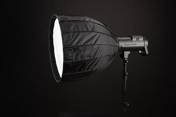 Modern octobox, on black background. Equipment for photo studios and fashion photography. Photographic lighting. Preparation for studio shooting.