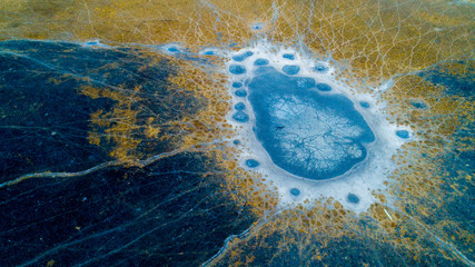 Aerial view of animal tracks near a dried-up waterhole in the Okavango Delta in Botswana in the dry...