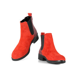 Red suede ankle boots on an isolated white background