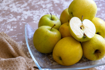 apples on a plate on the table in the kitchen. Chantecler apples.