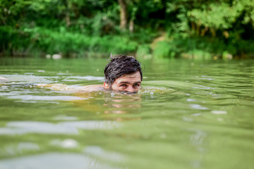 Enjoying summer. time to relax. bearded man swimming in lake. summer vacation. mature swimmer. brutal hipster with wet beard. refreshing in river water. water beast. furry monster. wild man