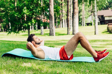 side view of handsome sportsman doing do abs on fitness mat © LIGHTFIELD STUDIOS