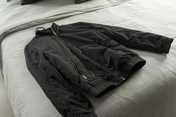 Black jacket on bed,man cloth prepare to dress.