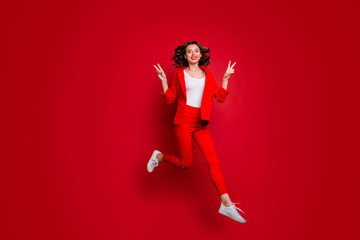 Fototapeta na wymiar Full body photo of charming woman making v-signs jumping isolated over red background