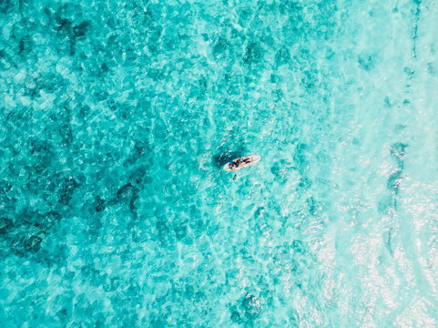 People On Kayak Swim In Blue Ocean. Aerial View