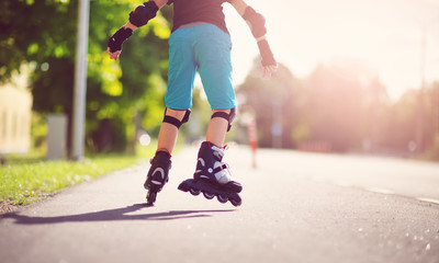 child on roller Skates in the evening - obrazy, fototapety, plakaty