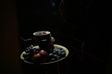 bowl with hookah tobacco. berries on a black background. shiisha smoking