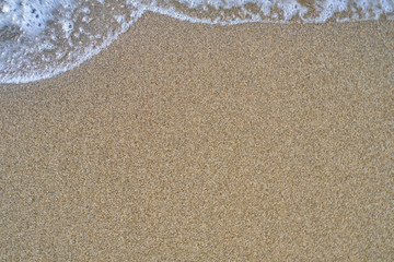 Beach Background with beautiful white foamy and wave from the sea,beach top view.