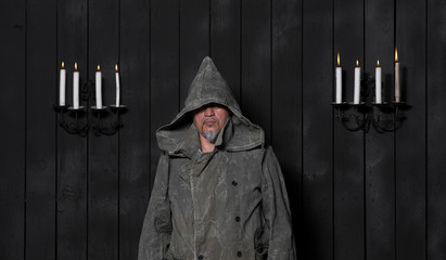 incognito portrait in the hood by candlelight