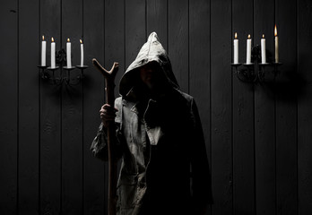 incognito portrait in the hood by candlelight