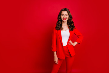 Portrait of elegant lady looking with toothy smile wearing suit isolated over red background