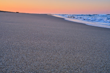 Sunrise over the ocean waves, spray.
