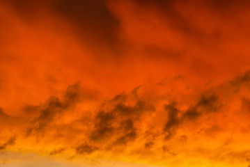 Strange and mysterious sunset sky with golden clouds as alien planet atmosphere background