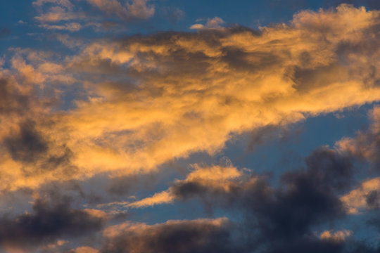 Sunset sky with golden clouds as background