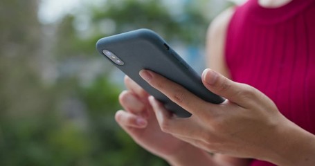 Close up of woman use of mobile phone in city