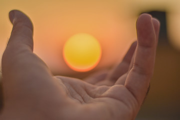 sun on male hand. Playing with sun