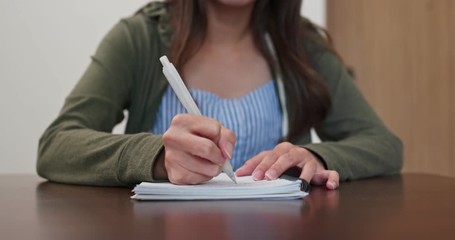 Woman write on notebook at home