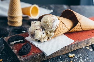 studio shoot of delicious ice cream in cone on wooden background