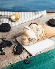 tasty ice cream in cones on wooden table