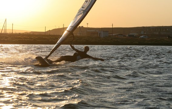 Windsurfer rides at sunset in the Black sea, Russia. - Powered by Adobe