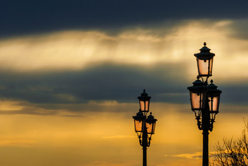 Old traditional Venice street lamps at sunset in a romantic and unique atmosphere (with copy space)