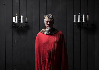 portrait of the old medieval king by candlelight
